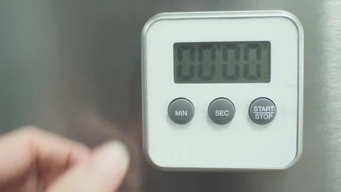 Medium close up shot set a timer on the fridge for 15 minutes for baking cooking Stock Footage 127952865