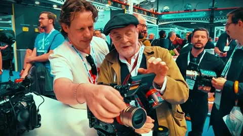 Medium Close-Up Shot of Two Men Inspecting ETERNA Camera Stock Footage 342855612