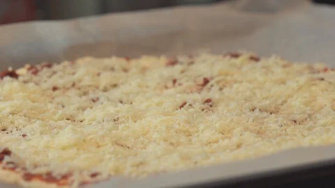 Medium close up spreading fresh minced meat as a pizza topping Stock Footage 127969179