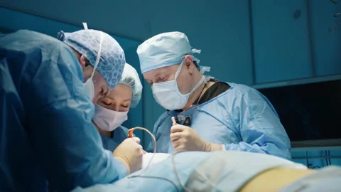 Medium close up of surgical team conducting plastic surgery procedure on face Stock Footage 239934659