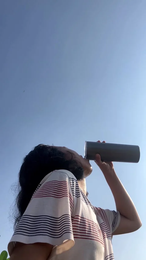 Medium Close Up of Young Woman Drinking Fresh Cold Water from a Metal Tumbler Stock Footage 337720508