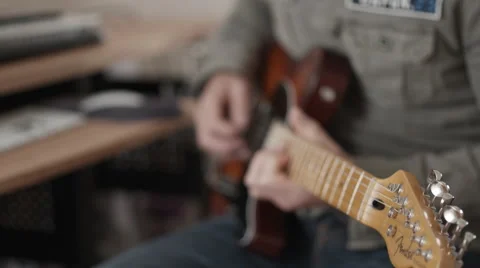 Medium closeup of man playing fender electric guitar - focus shifting Stock Footage 50245596