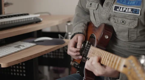 Medium closeup of man playing fender electric guitar - focus shifting Stock Footage 50245891