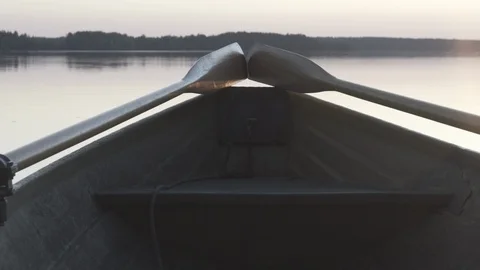 Medium closeup shot of the back end of a rowboat on a lake in Finland Stock Footage 113962631