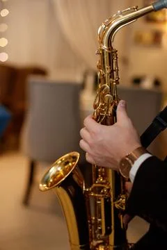 Medium closeup of unrecognizable Black jazz musician playing saxophone on stage Stock-Fotos