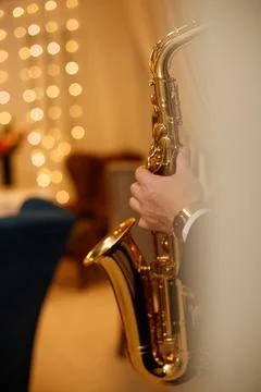 Medium closeup of unrecognizable Black jazz musician playing saxophone on stage Stock Photos