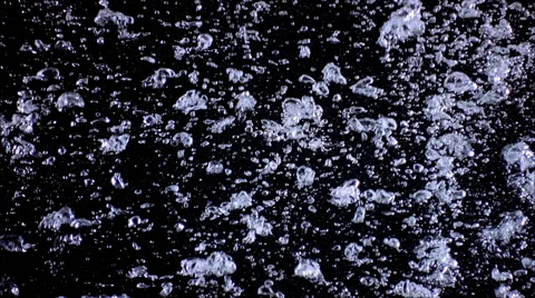 A medium concentration of tiny bubbles forming into larger masses as they rise Stock Footage 59529120