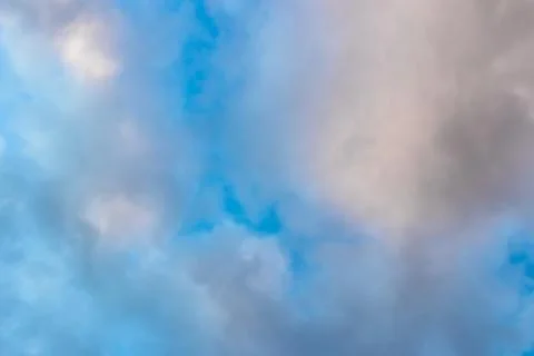 Medium dark clouds against a blue sky Stock Photos