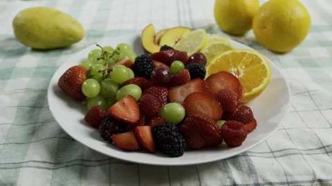 Medium dolly shot across fresh fruit on plate Stock Footage 341027099