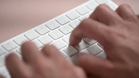 Medium elevated shot of unidentified person's hands typing on computer keyboard Stock Footage 277954642