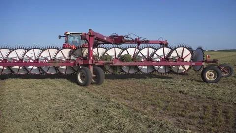 Medium Follow of Tractor and Rake Turning Stock Footage 221861838