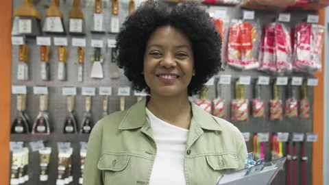 Medium front view shot of cheerful female African American shop owner looking at Stock Footage 277961414