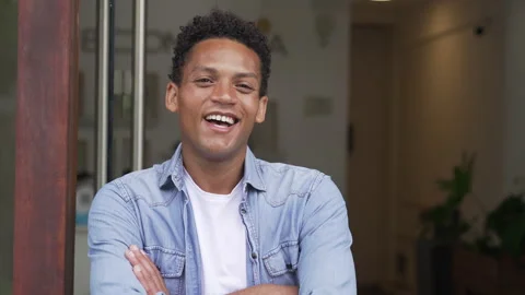 Medium front view shot of cheerful young African American man smiling at camera Stock Footage 277961743