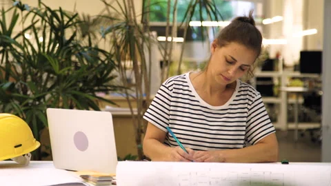 Medium front view shot of female engineer working with blueprints Stock Footage 277955954