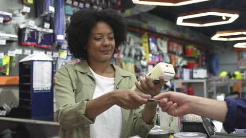 Medium front view shot of female small business owner taking card from paying Stock Footage 277961498