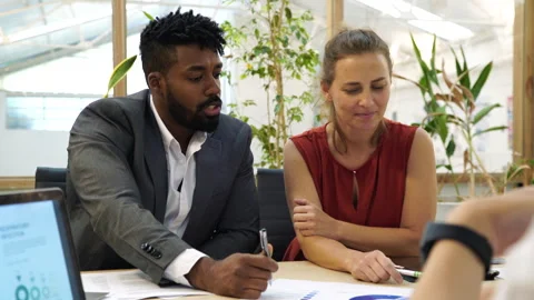 Medium front view shot of male African American manager talking to his staff Stock Footage 277956359