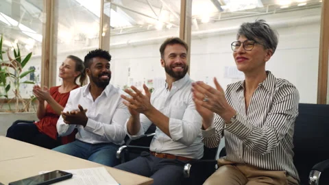Medium front view shot of small diverse group of coworkers clapping after Stock Footage 277957226