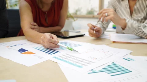 Medium front view shot of unrecognizable people sitting at worktable and Stock Footage 277956462