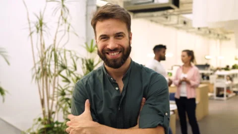 Medium front view shot of young entrepreneur smiling at camera with arms crossed Stock Footage 277957143