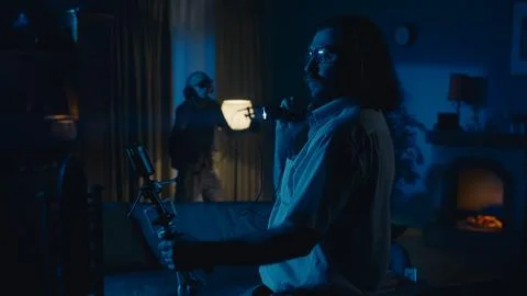 Medium-full photo capturing two ghost hunters entering a dark room in search for 스톡 사진