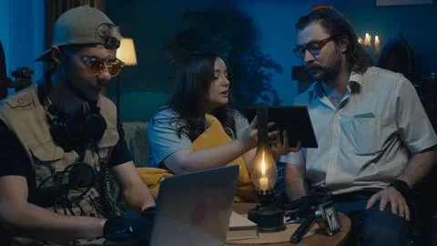 Medium-full photo capturing two ghost hunters and a victim sitting at the table 写真素材