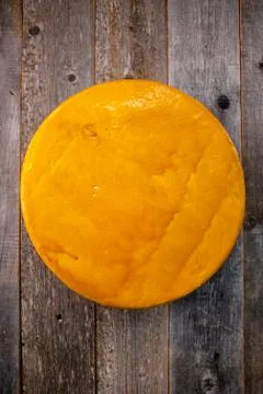 Medium hard cheese head edam gouda parmesan on wooden board with knife wooden Stock Photos