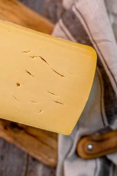Medium hard cheese head edam gouda parmesan on wooden board with knife wooden Foto stock