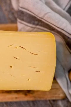 Medium hard cheese head edam gouda parmesan on wooden board with knife wooden Foto stock