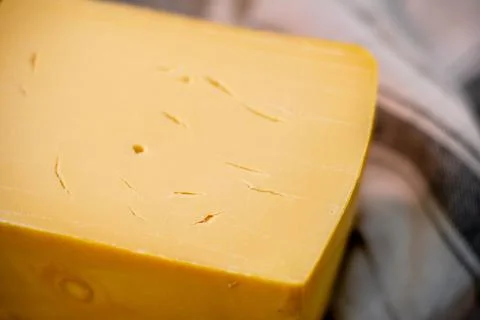 Medium hard cheese head edam gouda parmesan on wooden board with knife wooden Stock Photos