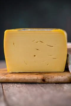 Medium hard cheese head edam gouda parmesan on wooden board with knife wooden 스톡 사진
