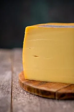 Medium hard cheese head edam gouda parmesan on wooden board with knife wooden 스톡 사진