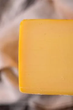 Medium hard cheese head edam gouda parmesan on wooden board with knife wooden 스톡 사진