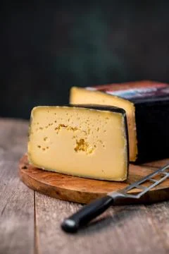 Medium hard cheese head gouda edam on wooden board with knife wooden texture Foto stock
