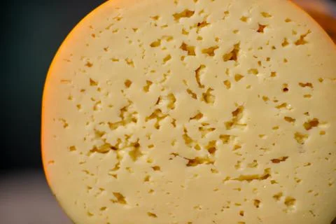 Medium hard cheese head gouda edam on wooden board with knife wooden texture Stock Photos