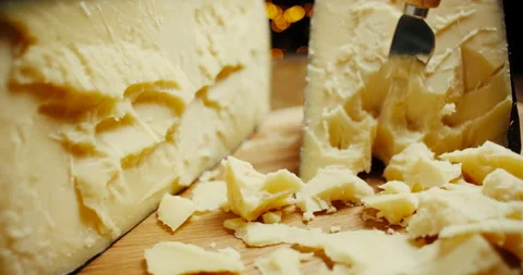 Medium hard cheese head parmesan on wooden board, with cheese parmesan knifes Video stock 146840067