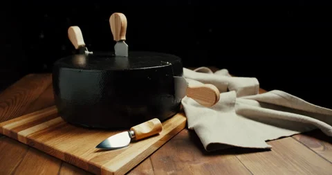 Medium hard cheese head parmesan on wooden board, with cheese parmesan knifes Video stock 146987735