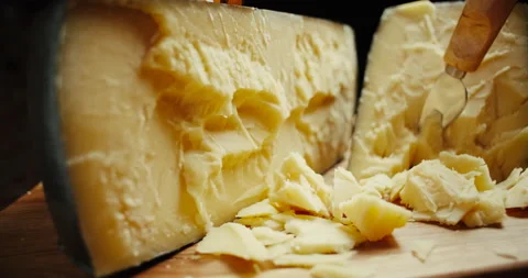 Medium hard cheese head parmesan on wooden board, rotaiting shot. Video stock 147088058