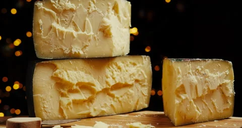 Medium hard cheese head parmesan on wooden board. Dolly-in shot. Stock Footage 147139415