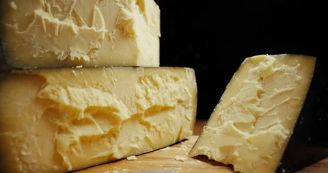 Medium hard cheese head parmesan on wooden board. Dolly-out shot. Stock Footage 147139614