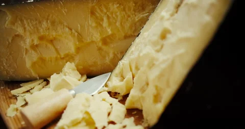 Medium hard cheese head parmesan on wooden board, rotaiting shot. Video stock 147139960