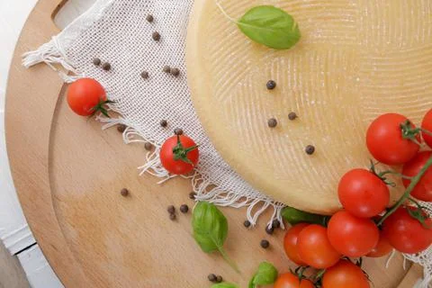 Medium hard cheese head parmesan on wooden board, with cheese parmesan with t 写真素材