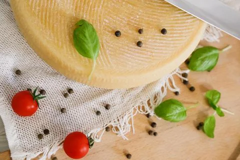Medium hard cheese head parmesan on wooden board, with cheese parmesan with t 写真素材