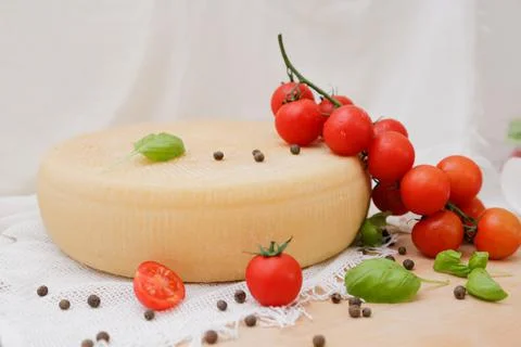Medium hard cheese head parmesan on wooden board, with cheese parmesan with t 写真素材
