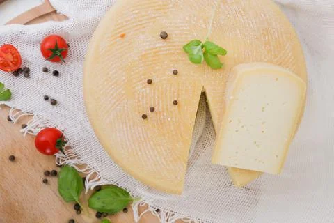 Medium hard cheese head parmesan on wooden board, with cheese parmesan with t Stock Photos