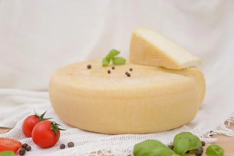 Medium hard cheese head parmesan on wooden board, with cheese parmesan with t 写真素材