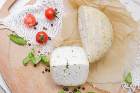 Medium hard cheese head parmesan on wooden board, with cheese parmesan with t Stock Photos