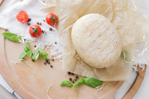 Medium hard cheese head parmesan on wooden board, with cheese parmesan with t 写真素材