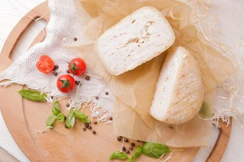 Medium hard cheese head parmesan on wooden board, with cheese parmesan with t 写真素材