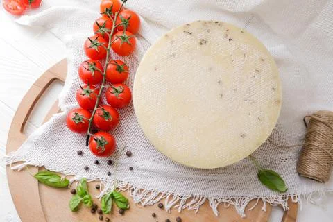 Medium hard cheese head parmesan on wooden board, with cheese parmesan with t 写真素材