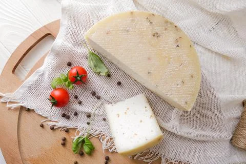Medium hard cheese head parmesan on wooden board, with cheese parmesan with t 写真素材
